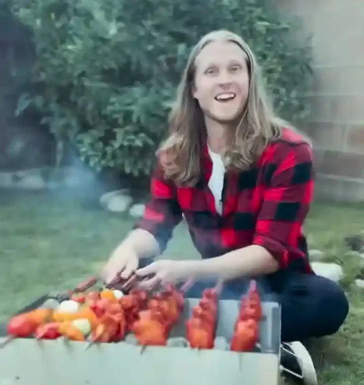 man in front of grill